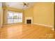 Living room featuring hardwood floors and a fireplace at 2534 Old Ashworth Nw Ln, Concord, NC 28027