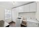 Bright laundry room with white cabinets and washer and dryer at 2628 Columbus Cir, Charlotte, NC 28208