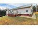 Rear view of a ranch house with a deck and brick accents at 2945 Parks Lafferty Rd, Concord, NC 28025