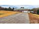 Brick ranch home with a green metal roof and a long driveway at 2945 Parks Lafferty Rd, Concord, NC 28025