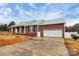 Brick ranch home with a green metal roof and attached garage at 2945 Parks Lafferty Rd, Concord, NC 28025