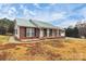 Brick ranch house with green metal roof and a covered porch at 2945 Parks Lafferty Rd, Concord, NC 28025