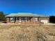 Brick ranch house with green metal roof, attached garage, and landscaped yard at 2945 Parks Lafferty Rd, Concord, NC 28025