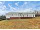 Rear view of a ranch house with a deck and green metal roof at 2945 Parks Lafferty Rd, Concord, NC 28025