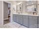 Bathroom with double vanity and gray cabinets at 4419 Woodlark Ln, Charlotte, NC 28211