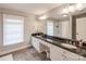 Elegant bathroom with double vanity and large mirror at 4419 Woodlark Ln, Charlotte, NC 28211