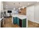 Open concept kitchen with a teal island and wine refrigerator at 4419 Woodlark Ln, Charlotte, NC 28211