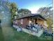 Side view of the house showcasing wood siding and a spacious yard at 50 Ranlo Ave, Gastonia, NC 28054