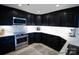 Modern kitchen with dark cabinetry, quartz countertops and stainless steel appliances at 555 E Catawba St, Belmont, NC 28120