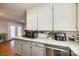 Modern kitchen with stainless steel appliances and white cabinets at 708 N Main St, Lowell, NC 28098