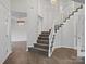 Elegant staircase with carpeted steps and wooden railing at 9114 Twilight Hill Ct, Charlotte, NC 28277