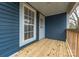 Back porch with wood flooring and blue siding at 1119 Poplar St, Albemarle, NC 28001