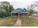 Blue house undergoing renovation with scaffolding and landscaping at 1119 Poplar St, Albemarle, NC 28001