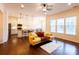 Bright living room with a yellow couch, kitchen, and backyard view at 11538 Warfield Ave, Huntersville, NC 28078