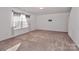 Spacious living room with neutral carpet and large window at 136 Quail Springs Rd, Statesville, NC 28677