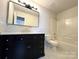 Bathroom with dark vanity, marble-look tile, and a bathtub at 1812 Winfield Dr, Monroe, NC 28110