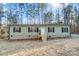 Green house with stone foundation and small porch at 1860 Bascom Ln, Midland, NC 28107