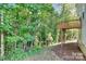 Landscaped backyard with a wooden deck at 2225 Southwind Dr, Charlotte, NC 28216