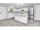 Bright kitchen featuring white cabinets, stainless steel appliances, and an island at 2225 Southwind Dr, Charlotte, NC 28216