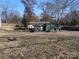 Large backyard with overgrown grass and a dilapidated shed at 228 Hampton Church Rd, Charlotte, NC 28262