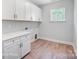 Laundry room with white cabinets and flooring at 3252 Mcharney Dr # 37, Harrisburg, NC 28075