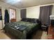 Spacious bedroom with a king-size bed and dark green comforter at 344 Fletcher Rd, Union Grove, NC 28689