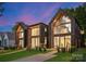 Modern three-unit building with dark exterior and large windows at 4026 Chevington Rd # 101, Charlotte, NC 28226