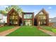 Contemporary three-unit building showcasing expansive windows and backyard at 4026 Chevington Rd # 101, Charlotte, NC 28226
