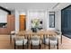 Modern dining room with light wood table and six chairs, open to kitchen at 4026 Chevington Rd # 102, Charlotte, NC 28226