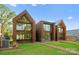 Rear view of three modern townhouses with metal siding and private yards at 4026 Chevington Rd # 103, Charlotte, NC 28226