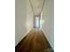 Long hallway with light walls and laminate flooring at 46 Kidd And Brown Rd, Hiddenite, NC 28636