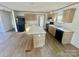 Modern kitchen with light wood cabinets, island, and black appliances at 46 Kidd And Brown Rd, Hiddenite, NC 28636