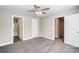 Bedroom with carpet, ceiling fan and access to bathroom and stairs at 925 Pineridge Se St, Concord, NC 28025