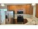 Kitchen with wood cabinets, stainless steel appliances and island at 1001 Jessica Ln, Matthews, NC 28104