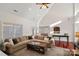 Spacious living room with vaulted ceilings, a cozy fireplace, and hardwood floors at 10113 Allison Taylor Ct, Cornelius, NC 28031