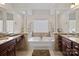 Luxurious main bathroom with double vanity and soaking tub at 10113 Allison Taylor Ct, Cornelius, NC 28031