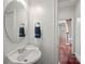 Convenient powder room with pedestal sink and oval mirror at 10113 Allison Taylor Ct, Cornelius, NC 28031