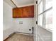 Laundry room with wood cabinets and built-in shelving at 110 Yorktowne St, Fort Mill, SC 29715