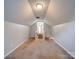 Large bonus room with vaulted ceiling and carpet at 11116 Northwoods Forest Dr, Charlotte, NC 28214