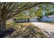 House exterior showcasing a tree-lined driveway and attached garage at 12610 Cumberland Crest Dr, Huntersville, NC 28078