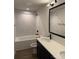 Modern bathroom with double vanity, soaking tub, and marble tile at 132 Breezewood Dr, Charlotte, NC 28262