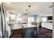 Open concept kitchen with island, stainless steel appliances, and dark hardwood floors at 14126 Waterlyn Dr, Charlotte, NC 28278