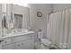 Clean bathroom with white vanity, toilet, and shower/tub combo at 14711 Batteliere Dr, Charlotte, NC 28278