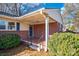 Brick front porch with a blue door and small shrubs at 187 Shumaker Dr, Statesville, NC 28625