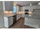 Modern kitchen with white cabinets, granite countertops, and stainless steel appliances at 2008 Laurel Village Cir, Belmont, NC 28012