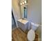 Updated bathroom with gray vanity, new toilet, and wood-look flooring at 2117 Arden Dr, Monroe, NC 28112