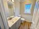 Clean bathroom with gray vanity, new toilet, and a window at 2117 Arden Dr, Monroe, NC 28112
