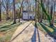 Long driveway leading to a two-story house nestled among trees at 2117 Arden Dr, Monroe, NC 28112