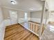 Bright entryway with white wood railing and light brown floors at 2117 Arden Dr, Monroe, NC 28112