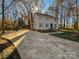 Gray house with blue door, surrounded by trees and a paved driveway at 2117 Arden Dr, Monroe, NC 28112